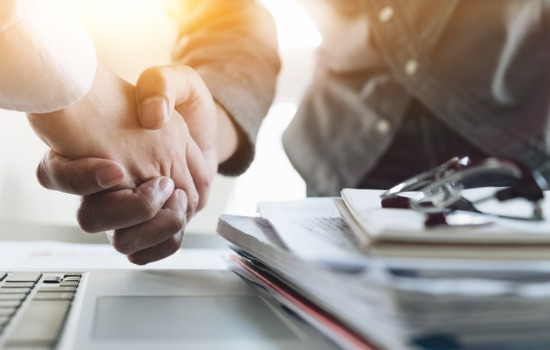 A Corporate Lawyer in South Carolina shaking hands with a business owner