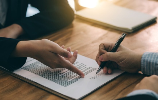 An attorney going over a contract for Real Estate Law in Charleston SC