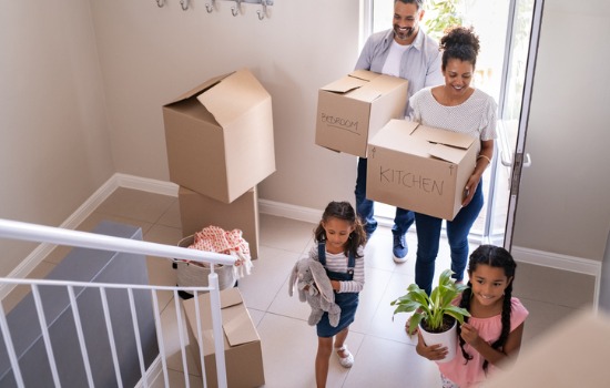 Family moving into a new house, after buying the property with help from a Home Purchase Attorney for Charleston SC