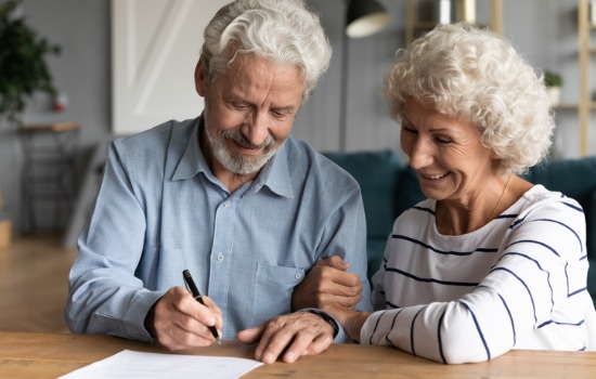 An elderly couple signing documents for a Revocable Trust in Mt. Pleasant SC