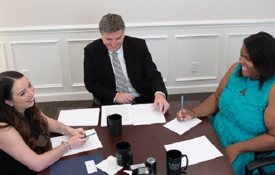 A Commercial Real Estate Attorney for Sullivan's Island SC working at a table with other attorneys
