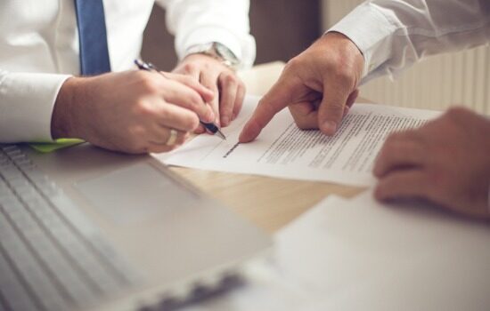 Attorney showing business man where to sign contract agreement for company in South Carolina