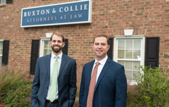 Attorneys standing outside of Buxton & Collie's office